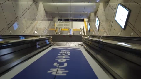 View inside subway underground station while on the escalator going down to the  Stock Footage 245325607