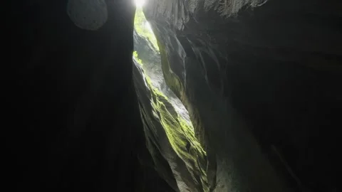 View inside Swiss Alps gorge with moss rocks and light shining from above Stock Footage 320103467