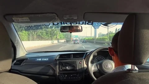View from inside a taxi with a man driving a taxi Stock Footage 333546409
