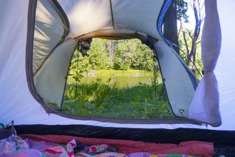 View from inside tent to the forest and lake Stock-Fotos
