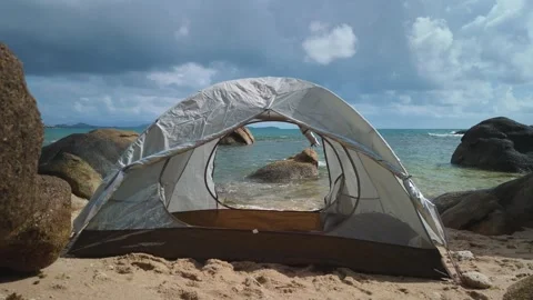 View from inside tent overlooking beautiful tropical beach with calm sea, rocks Stock Footage 312750450