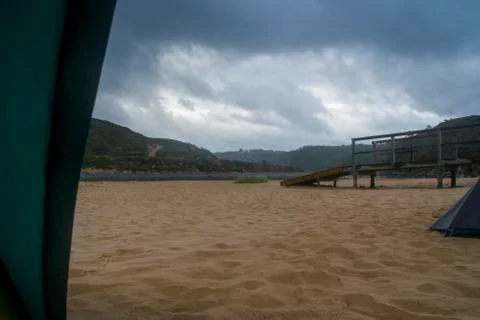 View from inside the tent to the sandy beach Stock Photos