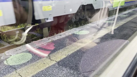 View from inside of train carriage on railway station platform with painted Stock Footage 269715356
