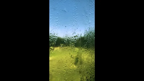 A view from inside the train through a rain-spattered window. Stock Footage 340168024