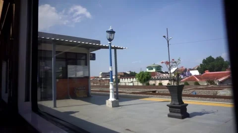 A view from inside a train window showing an empty station platform area Stock Footage 337858307