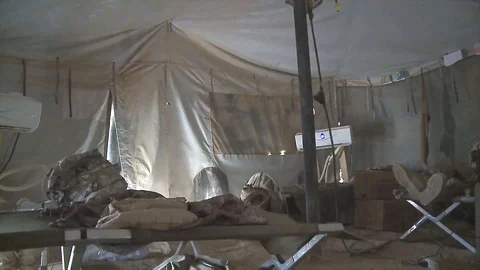 View from inside of an US Army camp tent being moved by the wind Stock Footage 85602125