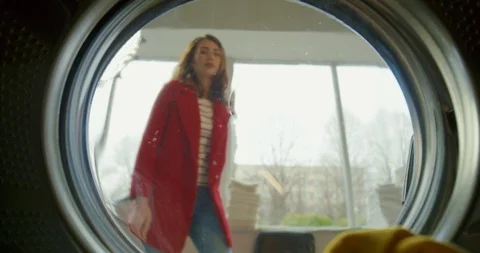 View from inside washing machine on Caucasian beautiful happy woman opening up Stock Footage 126733579