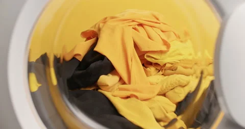 View from inside of washing machine full of laundry. Big heap of untidy clothes 库存影片 157677529