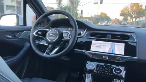 A view from inside a Waymo Self Driving Taxi vehicle driving down a street in Stock Footage 306042223