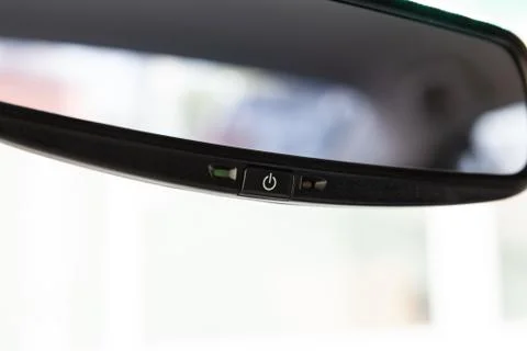 View to the interior of car with inside rear mirror button of auto dimming af Stock Photos