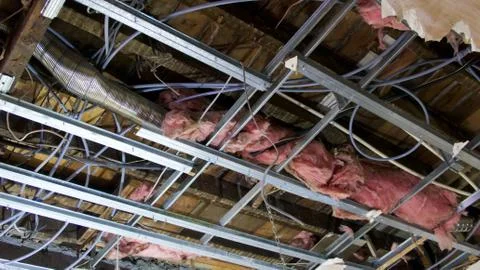 View of interior of ceiling space with ducting, wires and insulation Stock Photos