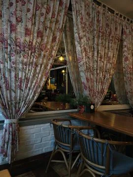 View of the interior with curtains and a table in a cafe Foto stock