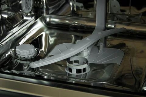 View of the interior of an empty opened dishwasher. Stock Photos