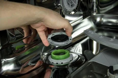 View of the interior of an empty opened dishwasher. Maintenance of home Stock Photos