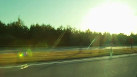 View from interior of moving car window on highway during summer travel, sun Stock Footage 335762488