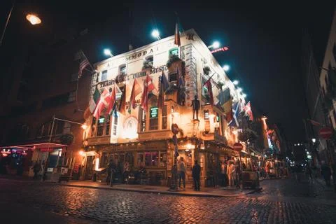 View of an Irish pub with flags and lights in Dublin. Stock Photos