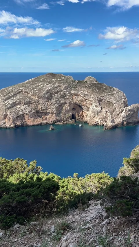 View of Isola di Foradada with its iconic natural arch from the Sardinian  Stock Footage 333795283