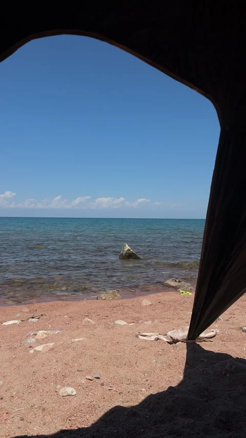 View of Issyk-Kul lake from inside tent, 4K vertical Stock Footage 342030263