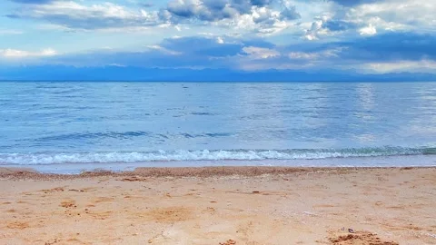 View of Issyk-Kul mountain lake, Kyrgyzstan. Waves lapping on the sandy shore Stock-Footage 249149673