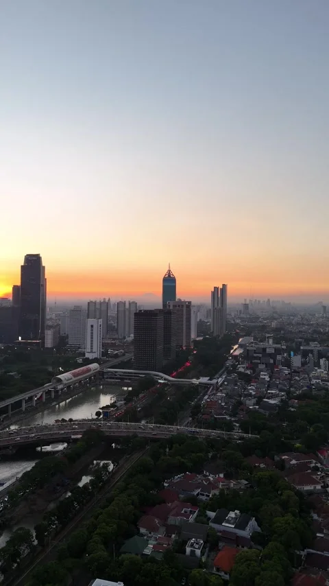 View of Jakarta at sunset with mountains in the background Video stock 259681344