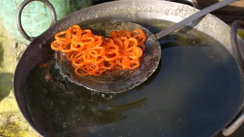 View of jalebi being deep fried in large metal pans, Nepal. Video stock 335607174