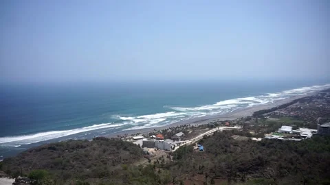View of Java&amp;#039;s southern coast and the crashing waves of Parangtritis Beach Stock Footage 346885902