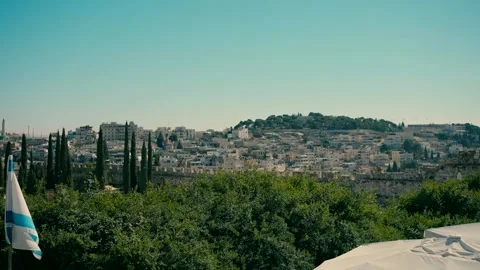 A view of Jerusalem with the Israeli flag in the foreground during the day. Video stock 231429752