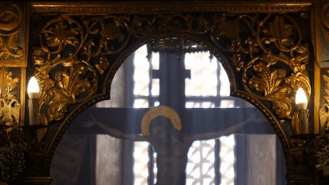 View of Jesus crucifix statue in a Greek church with light beaming through Stock Footage
