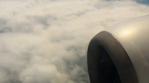 View of a jet air plane engine above clouds, travelling by air Stock Footage 63942404