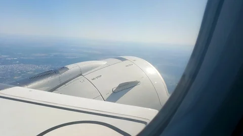 View of jet engine and the Earth from airplane window. Video stock 116349495