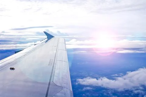 View of jet plane wing with cloud patterns Stock Photos
