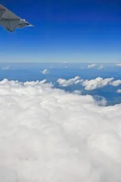 View of jet plane wing with cloud patterns Stock Photos