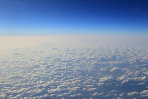 View of jet plane wing with cloud patterns Fotos Stock