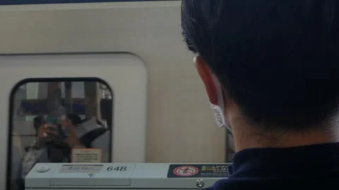 View at JR train platform to back ofpassenger people waiting for uppcomming.. Stock Footage 316390400