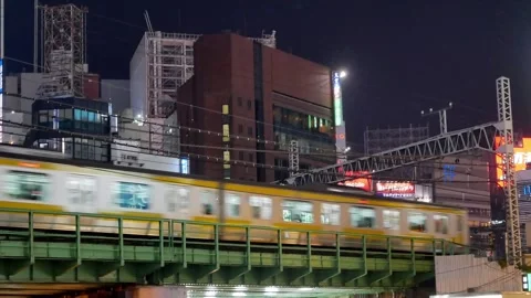 View to JR Train railway track withh train traffic at Shinjuku famous shopp.. Stock Footage 304097380