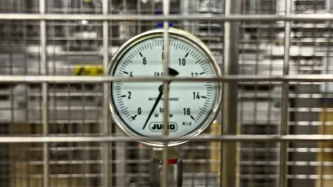 View of a JUMO pressure gauge behind a metal grid, France. Video stock 341453484
