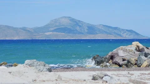 A view of Kalymnos seen from Kos, framed by lush palm trees and blooming fl.. Stock Footage 292753839