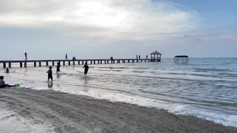 View of Karang Ginger beach, Central Java with a wooden bridge Stock Footage 262327000