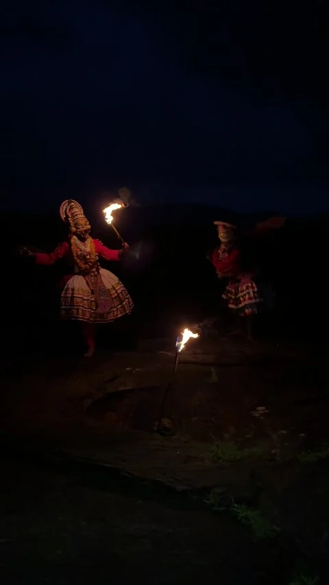 View of Kathakali performers with fire torches at night, India. Video stock 334996534