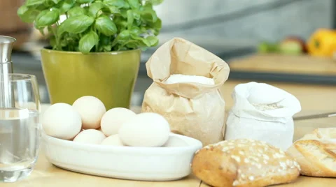 View of the kitchen table with a lot of ingredients on it, dolly shot Stock Footage