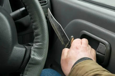View of the knife in the hand of the driver Stock Photos