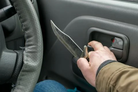 View of the knife in the hand of the driver Stock Photos