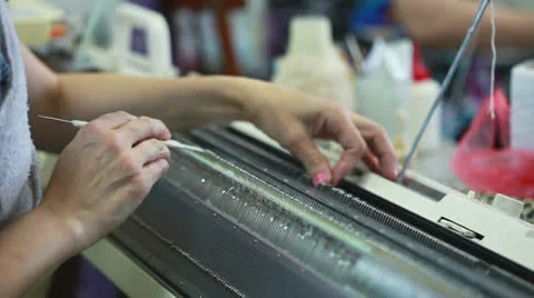 View of knitting machine operator working Stock Footage 24922524