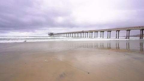 View of La Jolla pier in California. Waves on a cloudy day Stock Footage 154459798