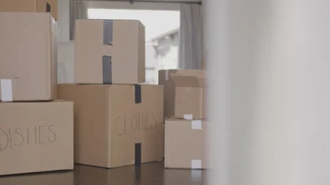 View of Labeled Moving Boxes Sitting on the Floor Inside of a House Stock Footage 270312542