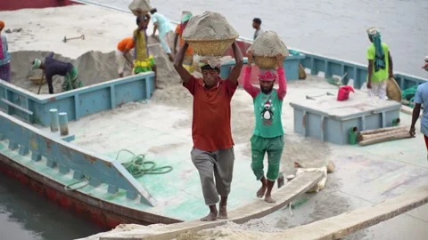 View of laborers carrying sand on a barge in Aminbazar, Bangladesh. Stock Footage 334996165