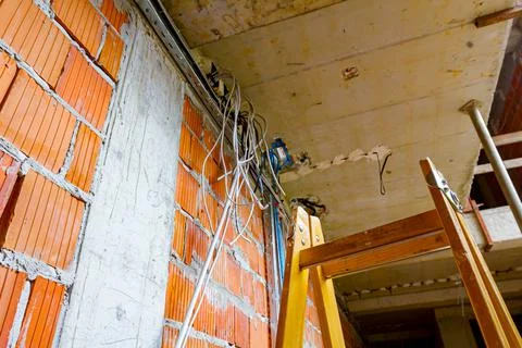 View on ladder and cable tray with bundle of cables between floors in build Stock Photos