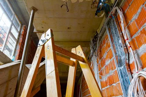 View on ladder and cable tray with bundle of cables between floors in build Stock Photos