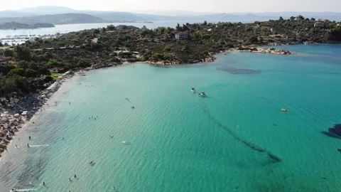 View on Lagonisi beach and Ormos Panagias with people and boats, Sithonia Stock Footage 160611920