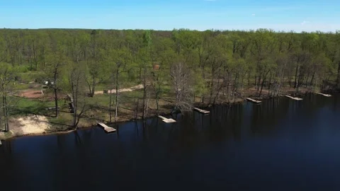 View of the lake from above. Early spring. Fishing lake with fishing platforms Stock Footage 274413847